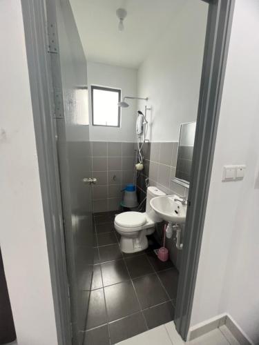 a bathroom with a toilet and a sink at 75 Suite (Tower B) in Papar