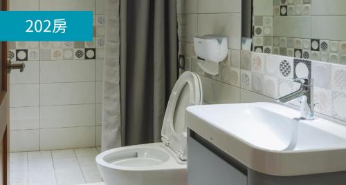 a bathroom with a sink and a toilet at Romance Guest House in Dalin