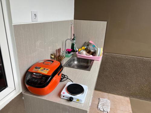 a kitchen counter with a toaster and a sink at Prestige Villa Rancamaya Bogor in Ciawi