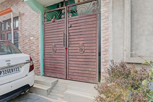a large wooden gate on the side of a house at OYO Royal inn homestay in Lucknow