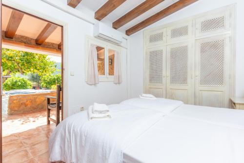 Casa Margarita في أندراتكس: غرفة نوم بيضاء مع سرير ونافذة كبيرة