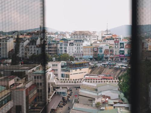 a view of a city with buildings and a street at Ho Cozy Đà Lạt Center in Da Lat