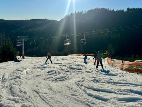 a group of people skiing on a ski slope at Gasthof Braun in Schmallenberg