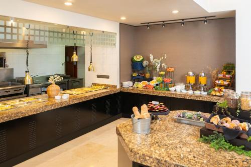 a large kitchen with many different types of food at Courtyard by Marriott San Luis Potosi in San Luis Potosí