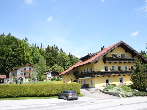 a car parked in front of a yellow building at Scenic Apartment in Krispl Salzburg with Swimming Pool in Krispl