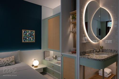 a bathroom with a sink and a mirror at Bare Hyphen - Bare Boutique Stays in Ho Chi Minh City