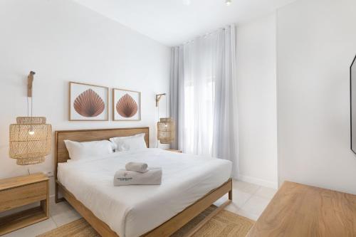 a white bedroom with a bed with a tray on it at Ocean Grand Gaube by Host Agents in Grand Gaube