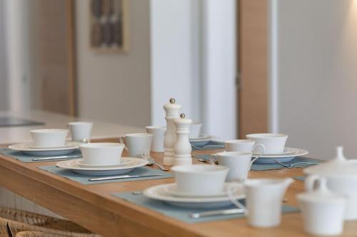 a table with white cups and chess pieces on it at Ocean Grand Gaube by Host Agents in Grand Gaube