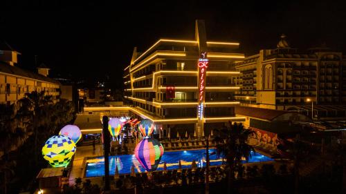 a building with balloons in front of it at night at GRAND KOLİBRİ PRESTİGE in Konaklı