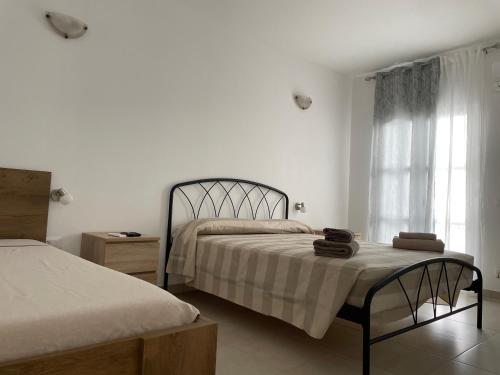 a bedroom with two beds and a window at Deda Apartments in Livadia