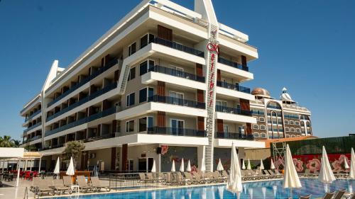 a hotel with a swimming pool in front of a building at GRAND KOLİBRİ PRESTİGE in Konaklı