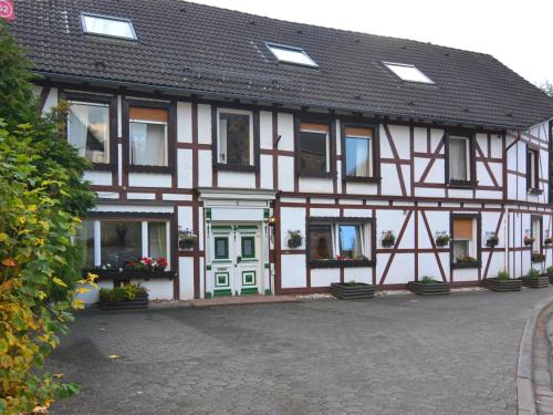 abered house with green doors and windows on a street at Modern group of homes close to Willingen and Winterberg with large garden in Medebach