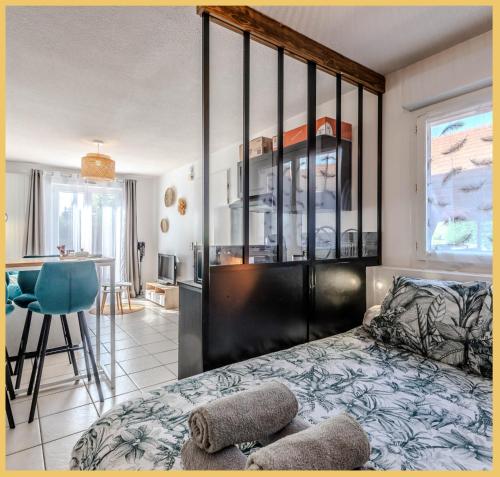 a bedroom with a bed and a dining room at Appartement Le Blansin in Saint Pierre en Faucigny