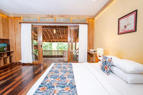 a living room with a white couch and a rug at Veranda Natural Resort in Kep