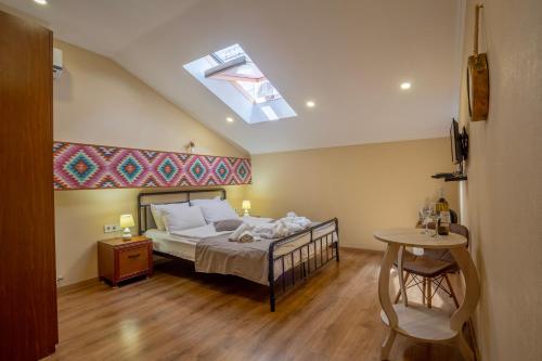 a bedroom with a bed and a skylight at Hotel Middleton in Tbilisi City