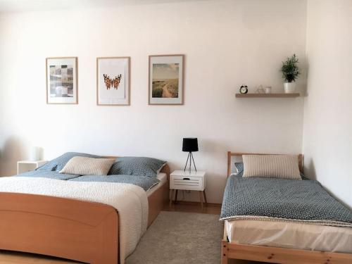 a bedroom with two beds and a table with a lamp at Feel Like Home @Strakova, Very central luxury APT in Bratislava