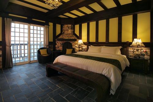 a bedroom with a large bed and a fireplace at Stuart Villa in Yanliau