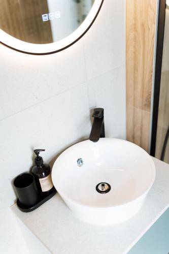 a white sink in a bathroom with a mirror at Békés Bucka Mátra in Parád