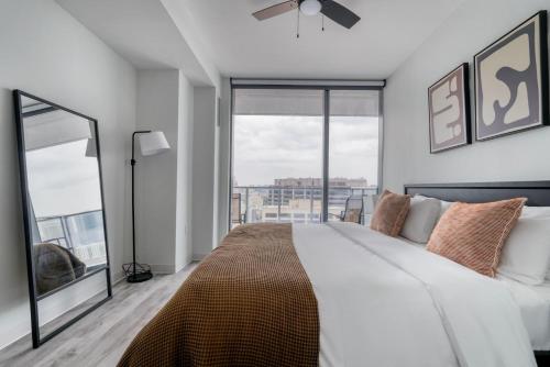 a bedroom with a large bed and a large window at Blueground Downtown pool lounge gym nr shops ATX-257 in Austin