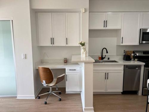 a white kitchen with a desk and a chair at Fortuna-Seaside Retreat in Santa Monica, steps to the beach, free parking in Los Angeles