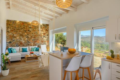 a kitchen and living room with a table and chairs at Althea Villa by breathtaking view in Agios Nikolaos