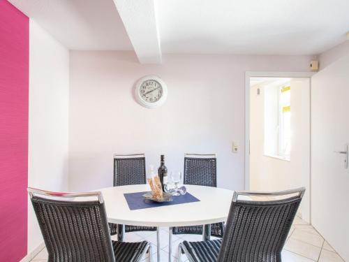 a dining room with a white table and chairs at Delightful holiday home in Battenberg near forest in Battenberg