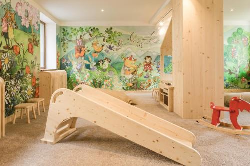 a childrens room with a mural of winnie the pooh at ARIETES MARMONT Resort TINY Houses in Štrba