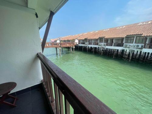 a view of the water from a balcony of a house at Cuti-cuti port dickson water chalet in Port Dickson