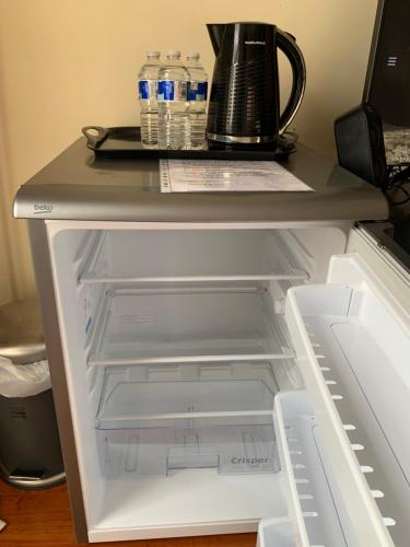 an open refrigerator with bottles of water in it at Superbly Furnished Apartment in Central London in London