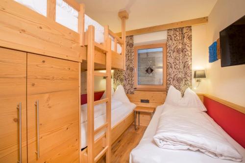 a room with two bunk beds and a desk at Chalet Königsleiten 117 A in Königsleiten
