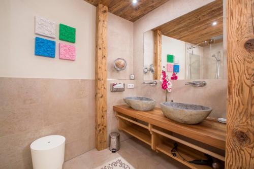 two sinks on a wooden counter in a bathroom at Chalet Königsleiten 117 A in Königsleiten