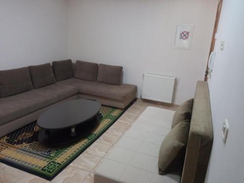 a living room with a couch and a table at Lovely Paradise in Sfax