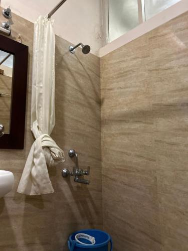 a bathroom with a shower with a sink and a mirror at AAC in Chennai