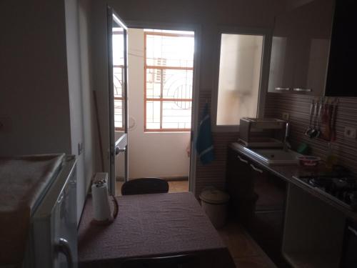 a small kitchen with a sink and a window at Lovely Paradise in Sfax