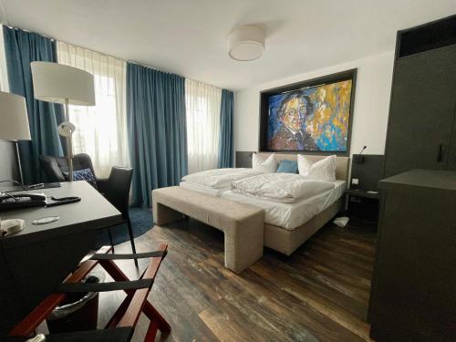 a hotel room with a bed and a desk and a desk at Hotel Am Schloss *** Superior in Tübingen