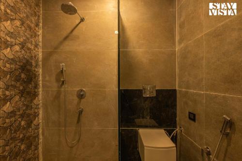 a shower stall with a toilet in a bathroom at StayVista at Silver Slopes with outdoor pool in Chandīgarh