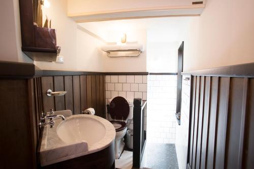 La salle de bains est pourvue d'un lavabo et de toilettes. dans l'établissement 1905 Heritage Corner, à Bangkok