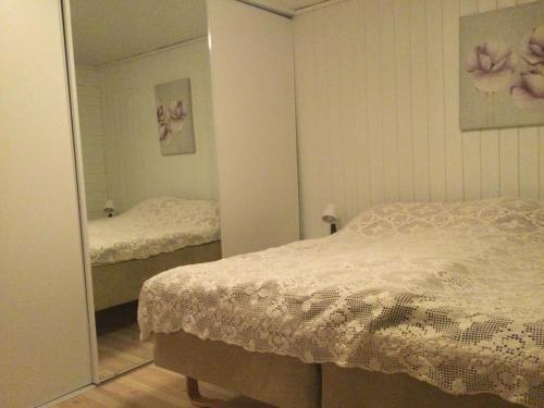 a bedroom with two beds and a mirror at Ryfylke garden Holta in Strand