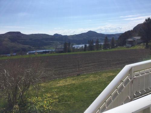 a view of a field from a porch at Ryfylke garden Holta in Strand