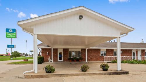 a building with awning in front of a parking lot at SureStay by Best Western Cameron in Cameron