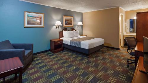 a hotel room with a bed and a couch at SureStay by Best Western Cameron in Cameron