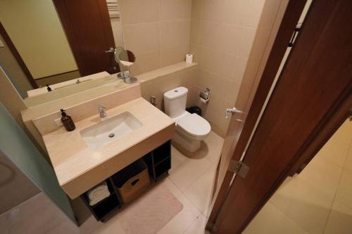 a bathroom with a sink and a toilet and a mirror at 2BR Penthouse in Anvaya Cove in Morong