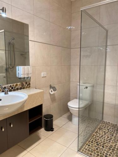 a bathroom with a toilet and a sink and a shower at Adelphi Apartments 3 or 3A - Downstairs 2 Bedroom or Upstairs King Studio with Balcony in Echuca