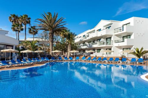 a large swimming pool in front of a hotel at THB Lanzarote Beach in Costa Teguise