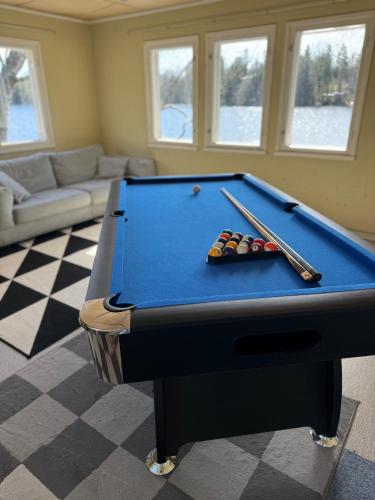 a pool table with cue balls on top of it at Lakeview apartment, Espoo in Espoo
