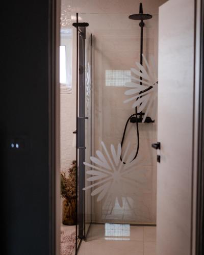 a bathroom with a shower with a snowflake wall at AVA HOUSE in Kranjska Gora