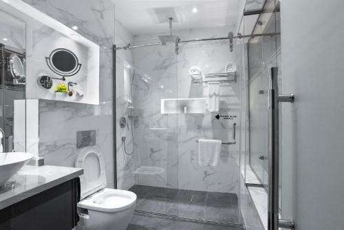 a bathroom with a shower and a toilet at Watercress Signature in Lagos
