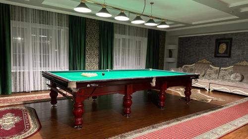 a living room with a pool table in it at HanHome in Talghar