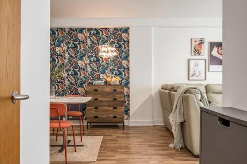 a living room with a table and a dining room at Central Belfast Apartments, Victoria Place in Belfast