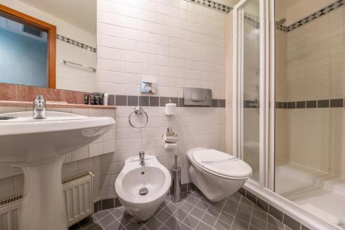 a bathroom with a sink and a toilet and a shower at Hotel Kinsky Fountain in Prague